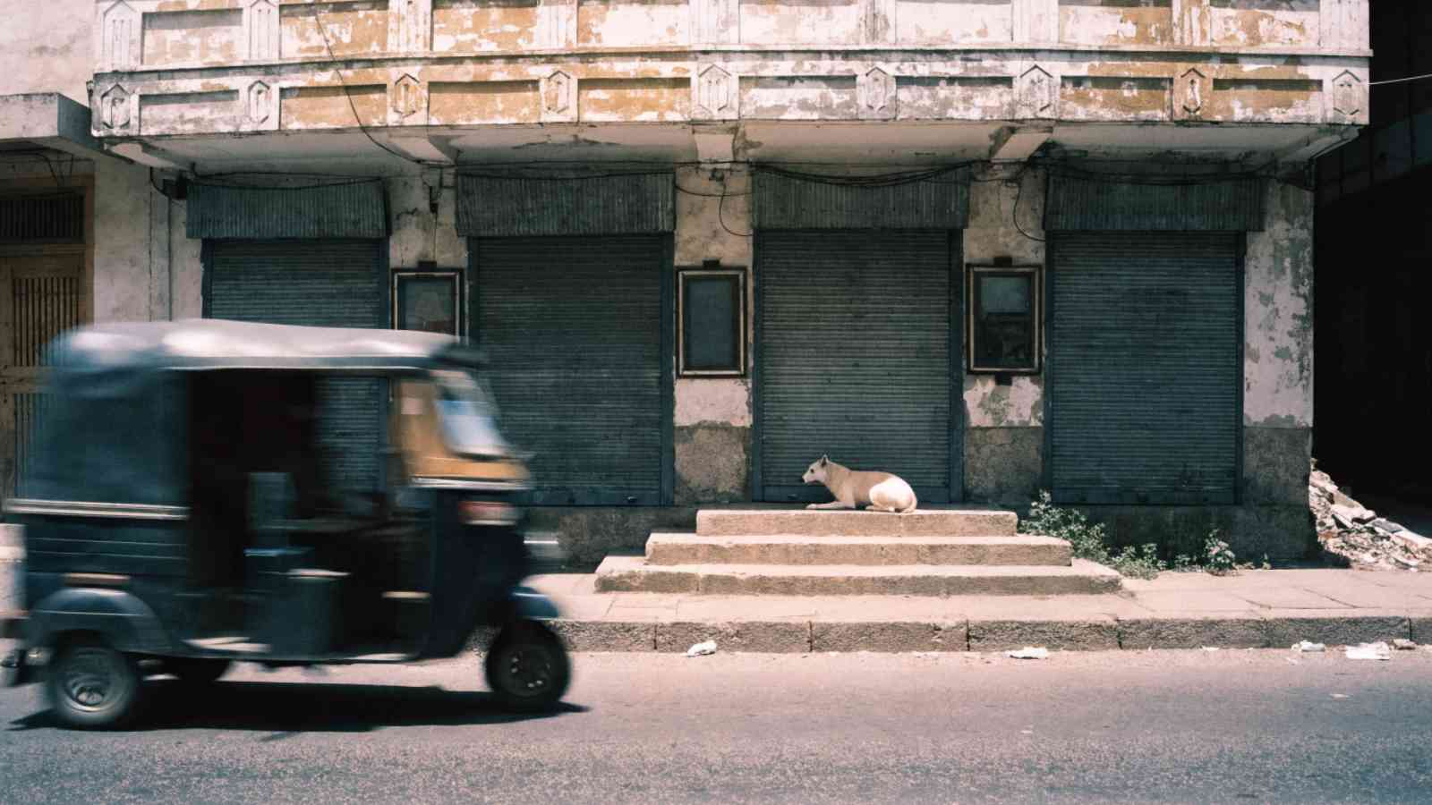 A closed single-screen cinema with rolling shutters down and empty display frames