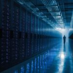 Long rows of server racks with indicator lights receding into the distance